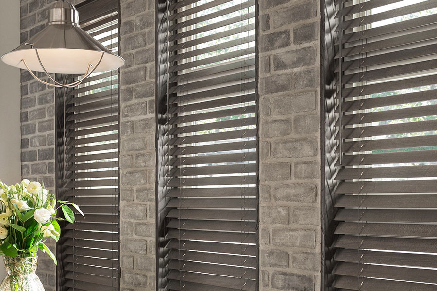 Gray wood blinds inside a large restaurant window