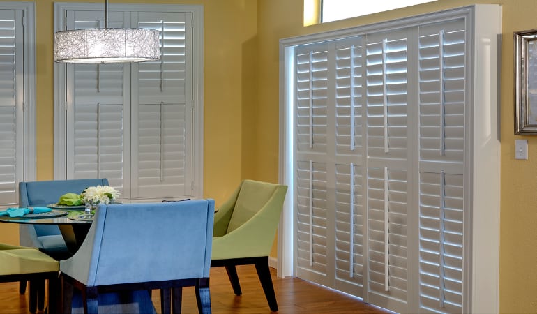 Plantation shutters on a French door work like common window shutters. Patio Doors with Plantation Shutters in Austin